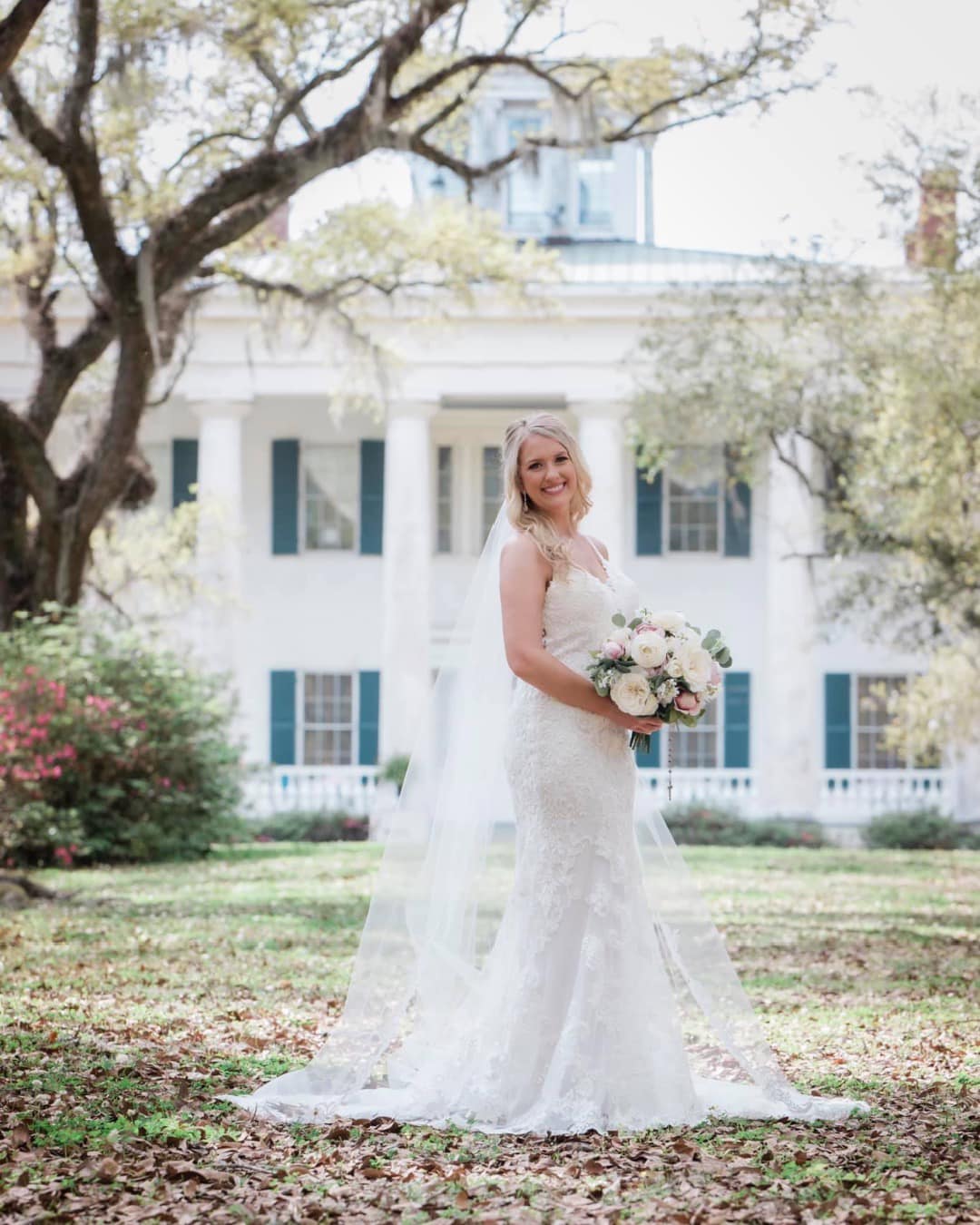 bride in front of historic home venue