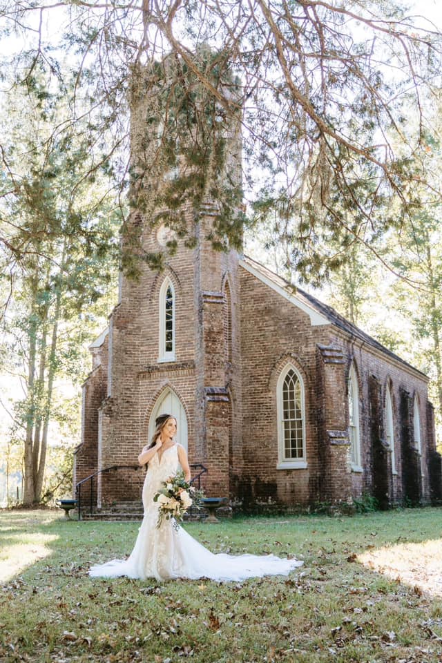 bride standing in front of historic church