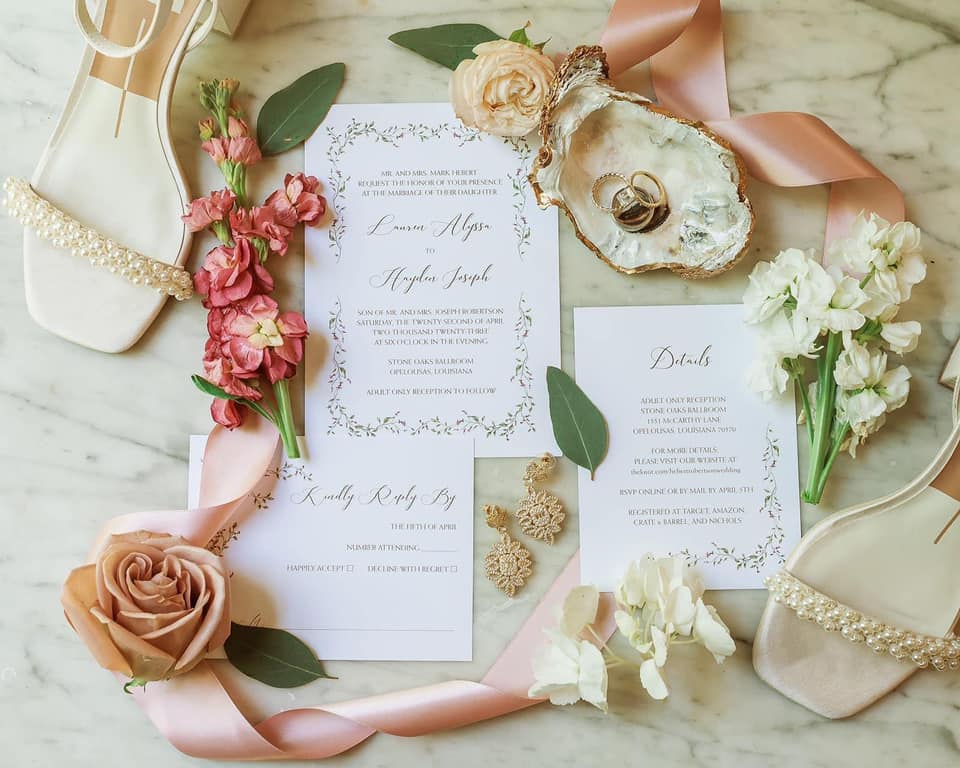 detail shot of wedding invitations, shoes, wedding rings, and flowers