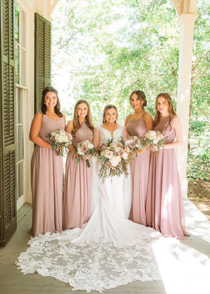 bride and bridesmaids in blush gowns with matching bouquets