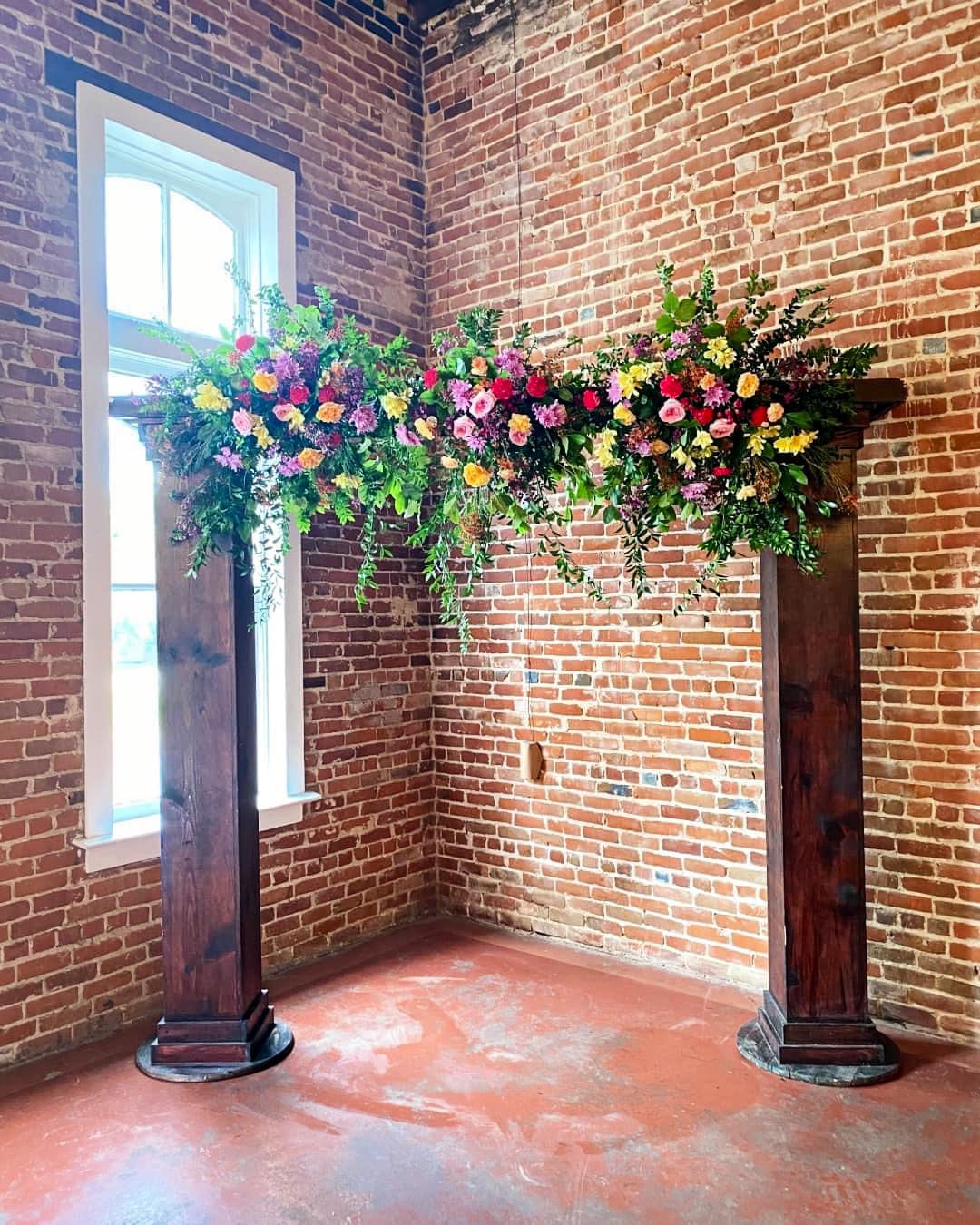 wedding arch with colorful summer flowers