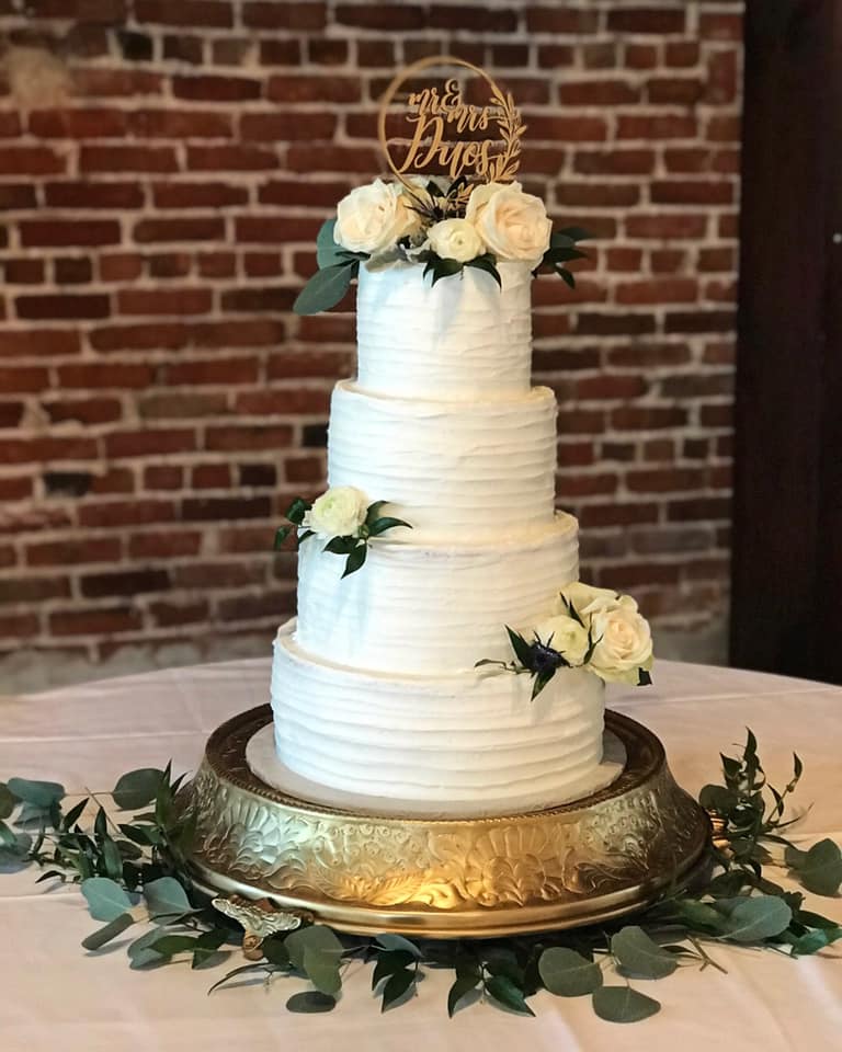 four tier wedding cake with white roses
