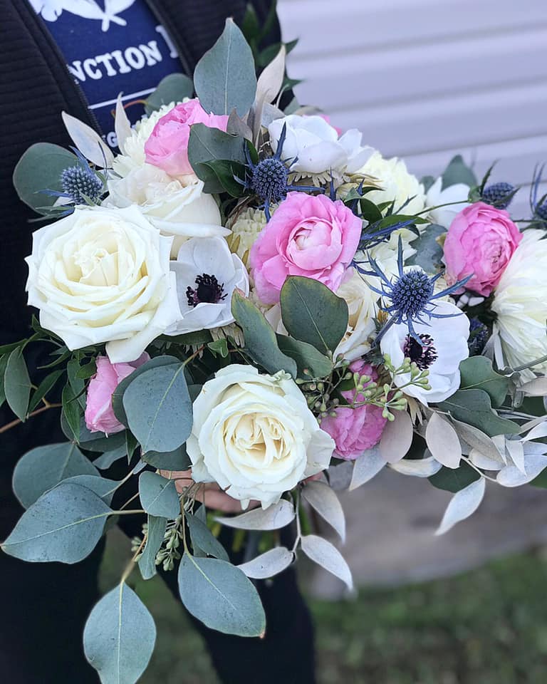 bride bouquet with white roses and anemones and pink peonies